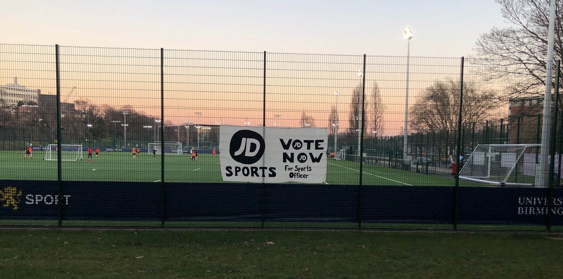 Image may contain: Team Sport, Team, Sport, Sports, Field, Building, Fence, Person, Human, People
