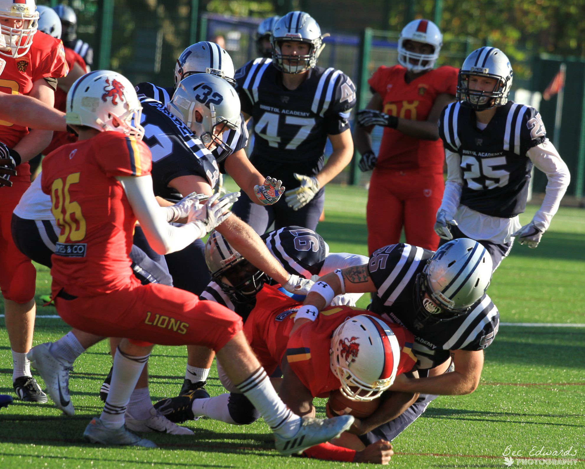 Image may contain: Crash Helmet, Footwear, Shoe, Football Helmet, American Football, Sport, Sports, Football, Team, Team Sport, People, Human, Person, Apparel, Helmet, Clothing
