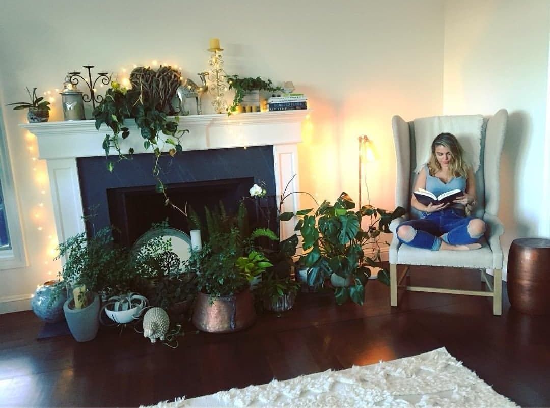 Image may contain: Dorm Room, Flower, Blossom, Living Room, Reading, Plant, Human, Person, Chair, Furniture, Bedroom, Room, Indoors