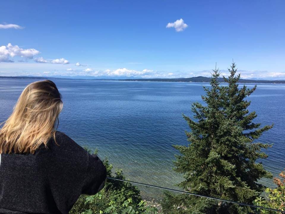 Image may contain: Landscape, Fir, Abies, Coast, Hair, Vegetation, Land, Sea, Ocean, Tree, Plant, Shoreline, Water, Outdoors, Nature, Female, Woman, Teen, Child, Blonde, Person, Human, Kid, Girl