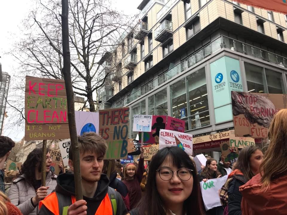 Image may contain: People, Text, Crowd, Protest, Parade, Person, Human, Accessories, Glasses, Accessory