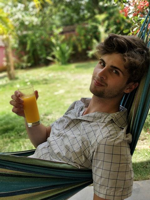 Image may contain: Yard, Nature, Outdoors, Chair, Hammock, Human, Person, Juice, Beverage, Drink, Furniture