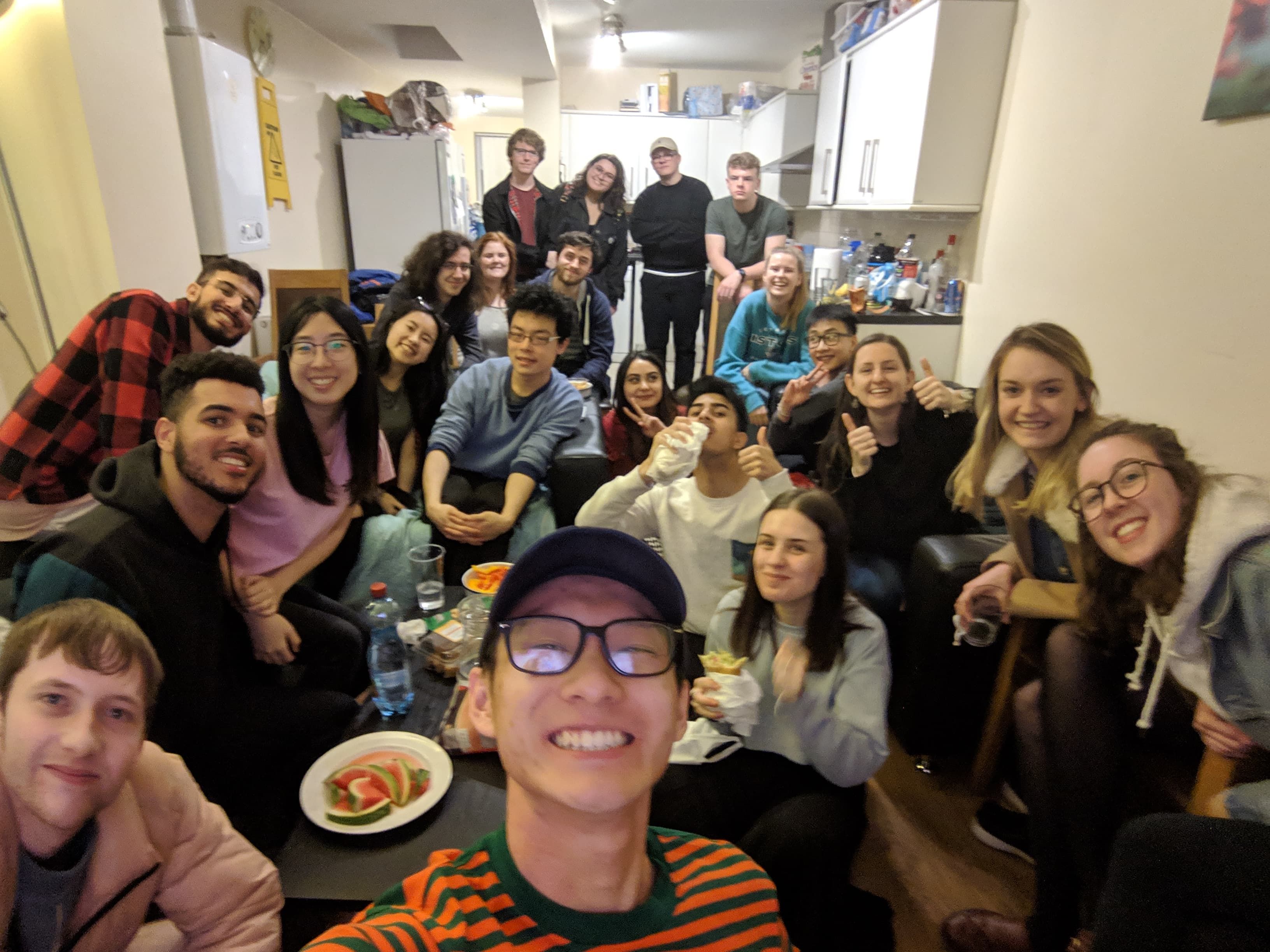 Image may contain: Audience, Crowd, Room, Apparel, Clothing, Indoors, Face, Dish, Sitting, Meal, Food, Food Court, Glasses, Accessories, Accessory, Restaurant, Person, Human