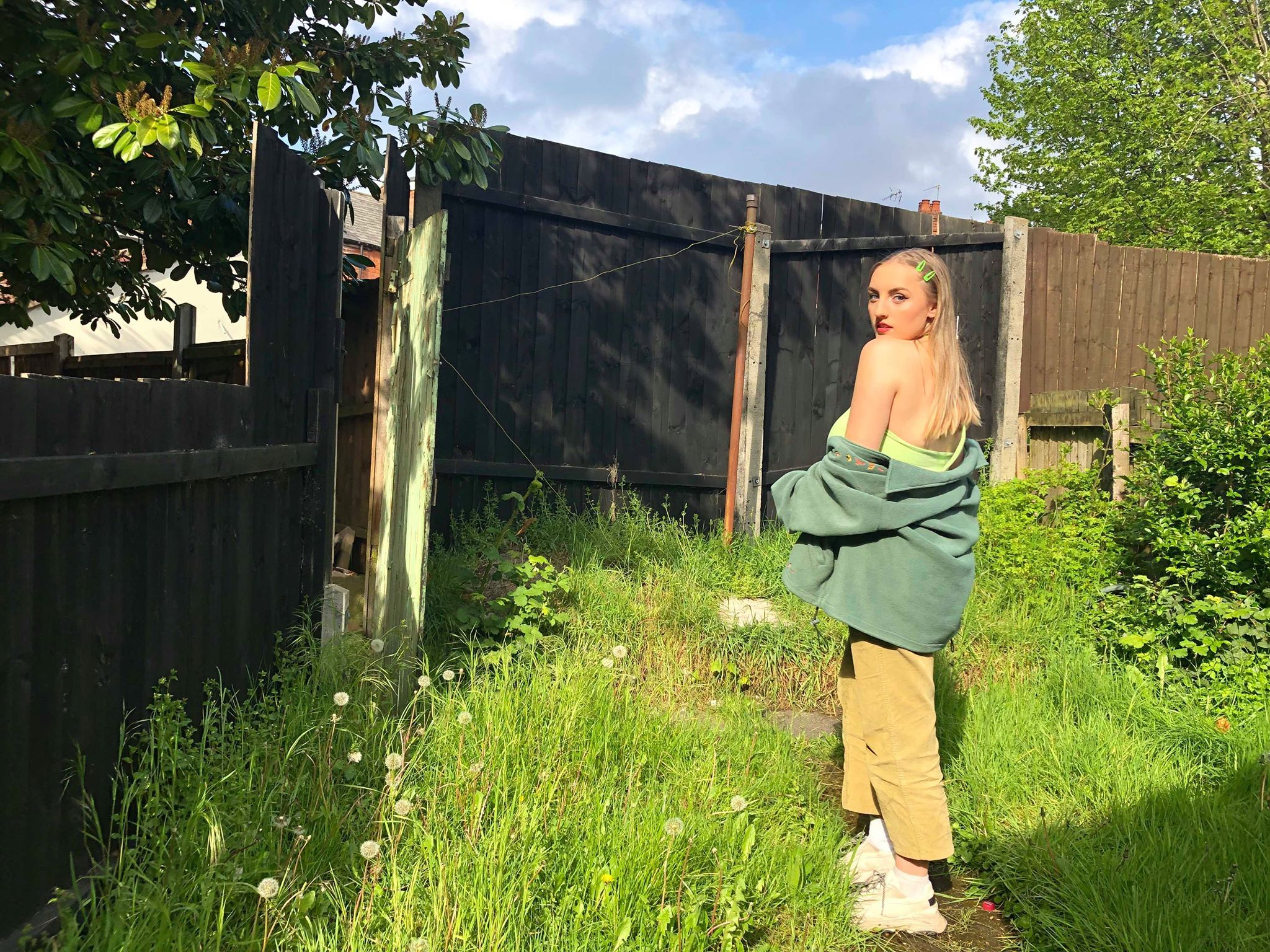 Image may contain: Countryside, Herbs, Planter, Vegetation, Grassland, Field, Garden, Tree, Grass, Jar, Vase, Pottery, Potted Plant, Yard, Clothing, Apparel, Plant, Nature, Outdoors, Person, Human