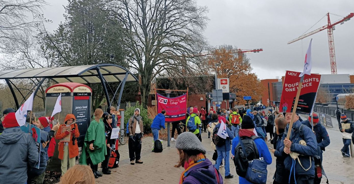 Image may contain: Transportation, Text, Crowd, Bus Stop, Tent, Apparel, Clothing, Pedestrian, Person, Human