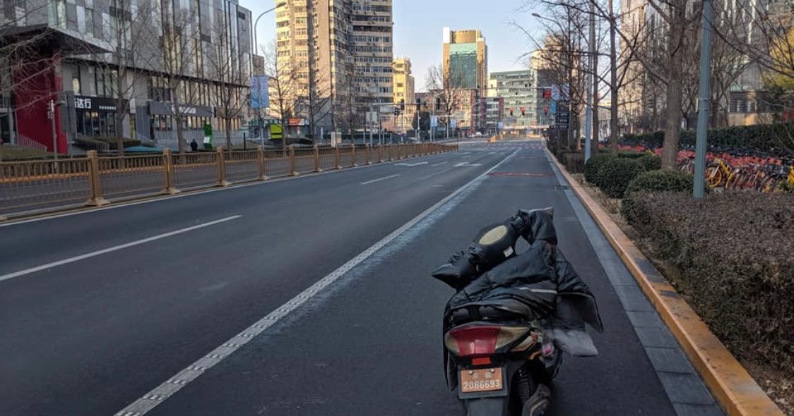 Image may contain: Freeway, High Rise, Moped, Vespa, Vehicle, Motorcycle, Transportation, Motor Scooter, Street, Urban, Building, City, Town, Road