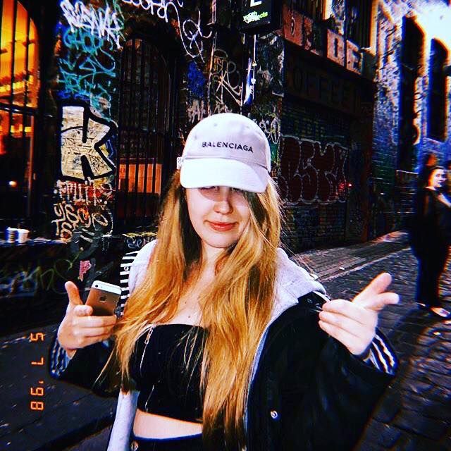 Image may contain: Brick, Girl, Woman, Portrait, Photo, Photography, Alley, Alleyway, Night Life, Accessories, Glasses, Accessory, Lighting, Costume, Female, Hat, Face, Apparel, Clothing, Person, Human, Building, Road, City, Street, Town, Urban