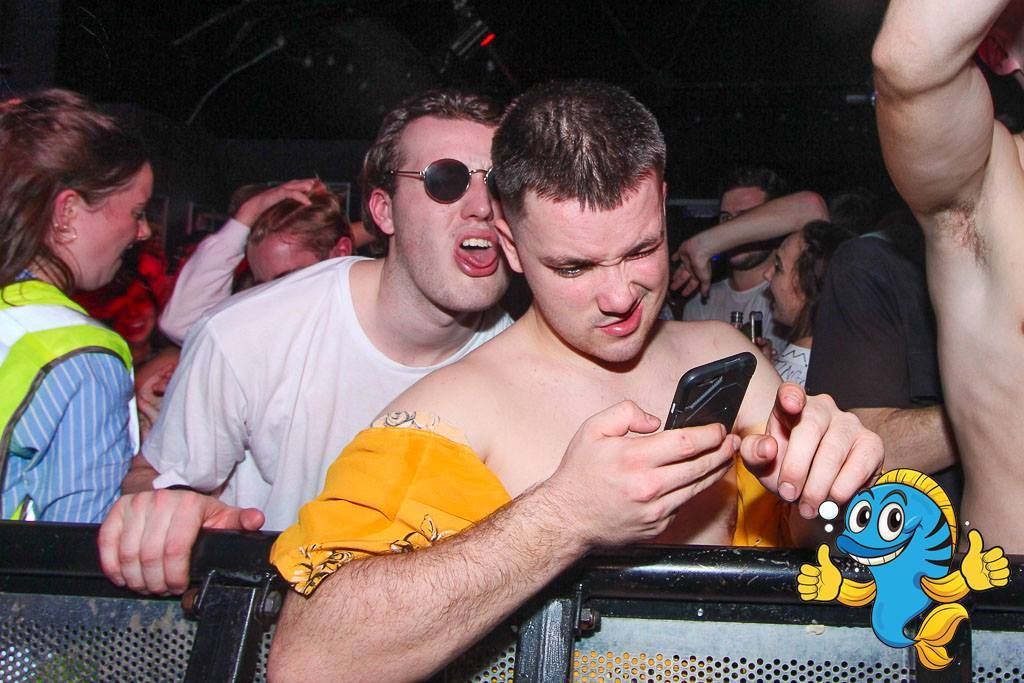 Image may contain: Night Life, Skin, Night Club, Club, Mobile Phone, Electronics, Phone, Cell Phone, Human, Person, Sunglasses, Accessories, Accessory