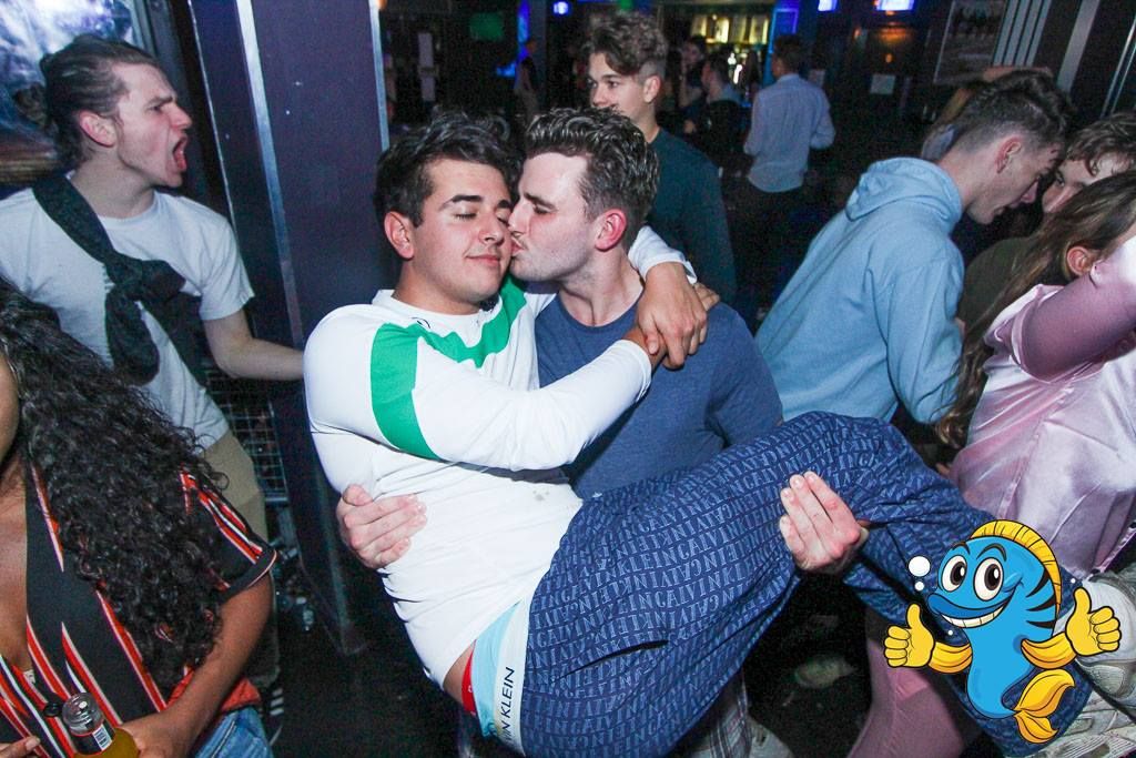 Image may contain: Pub, Bar Counter, Make Out, Party, Club, Dating, Night Life, Clothing, Apparel, Human, Person