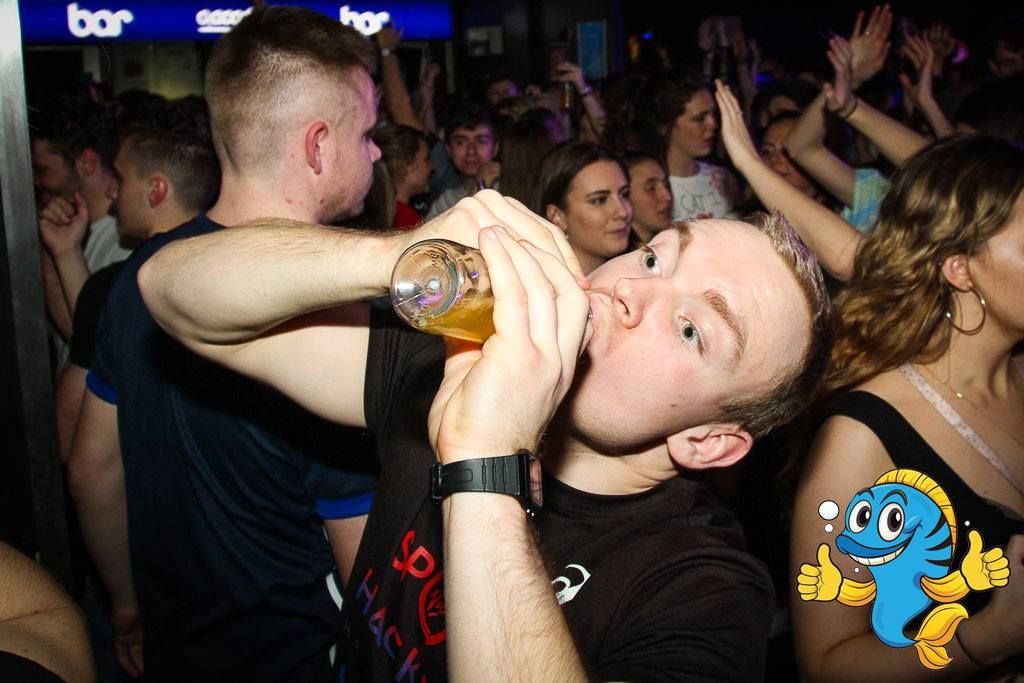 Image may contain: Crowd, Bar Counter, Pub, Beverage, Drink, Skin, Club, Night Club, Night Life, Party, Human, Person
