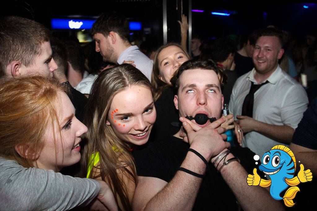Image may contain: Indoors, Interior Design, Leisure Activities, Audience, Crowd, Bar Counter, Pub, Night Club, Accessory, Accessories, Sunglasses, Club, Night Life, Party, Human, Person