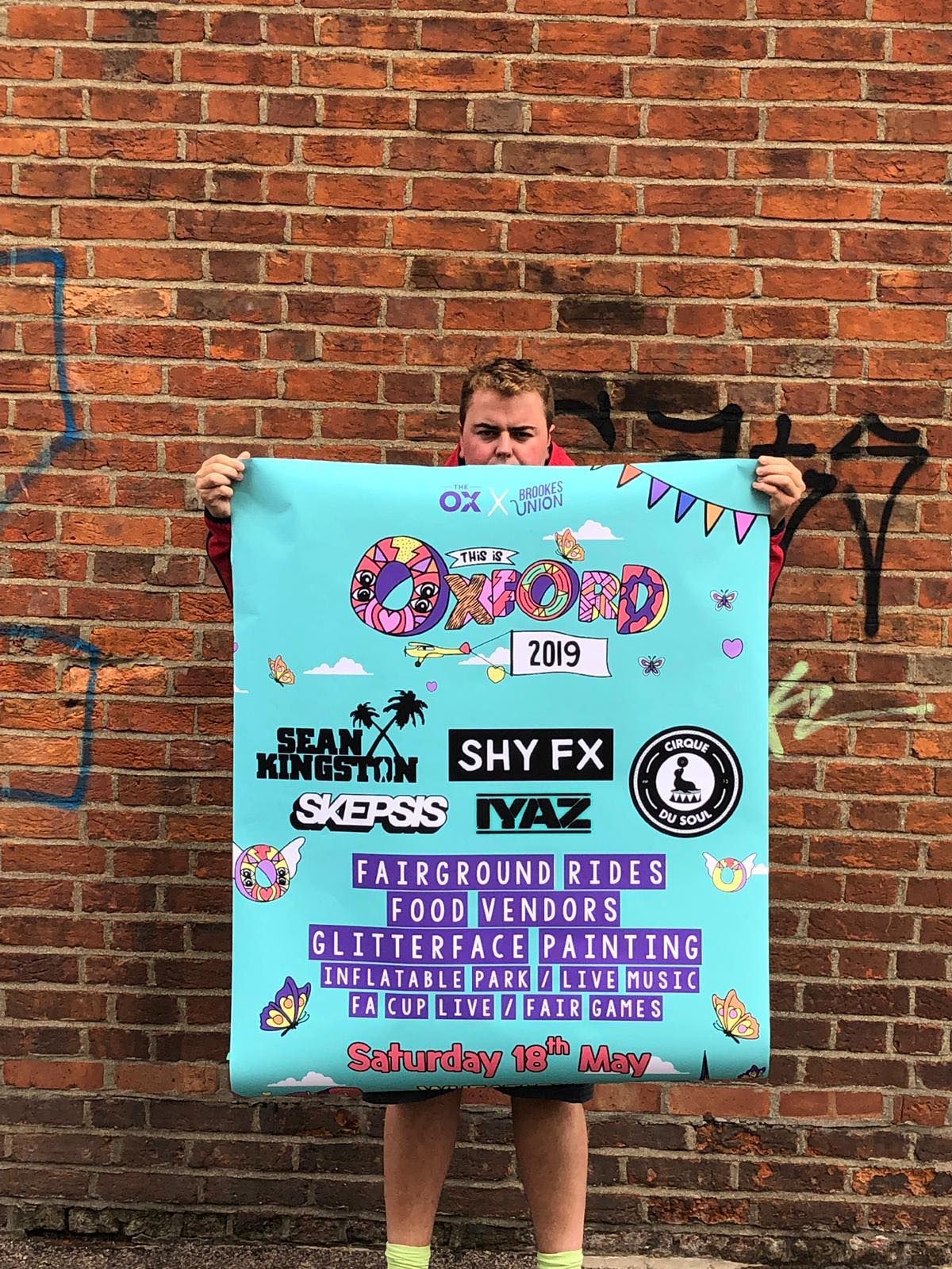 Image may contain: Sticker, Wall, Banner, Paper, Brochure, Flyer, Human, Person, Poster, Advertisement, Text, Label, Brick