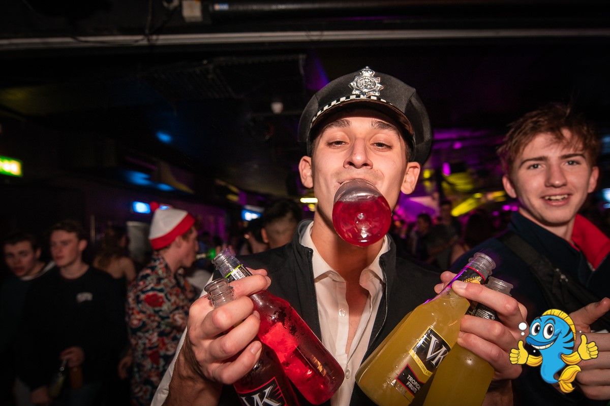 Image may contain: Bottle, Pub, Bar Counter, Beer, Alcohol, Drink, Beverage, Hat, Clothing, Apparel, Night Club, Toy, Club, Human, Person