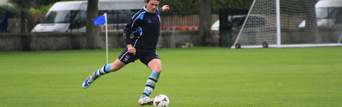 Footballer taking a beautiful kick