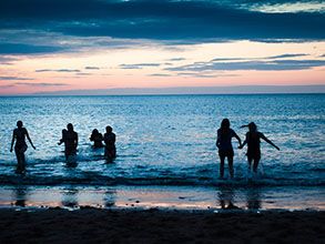 Students running into the sea at May Dip