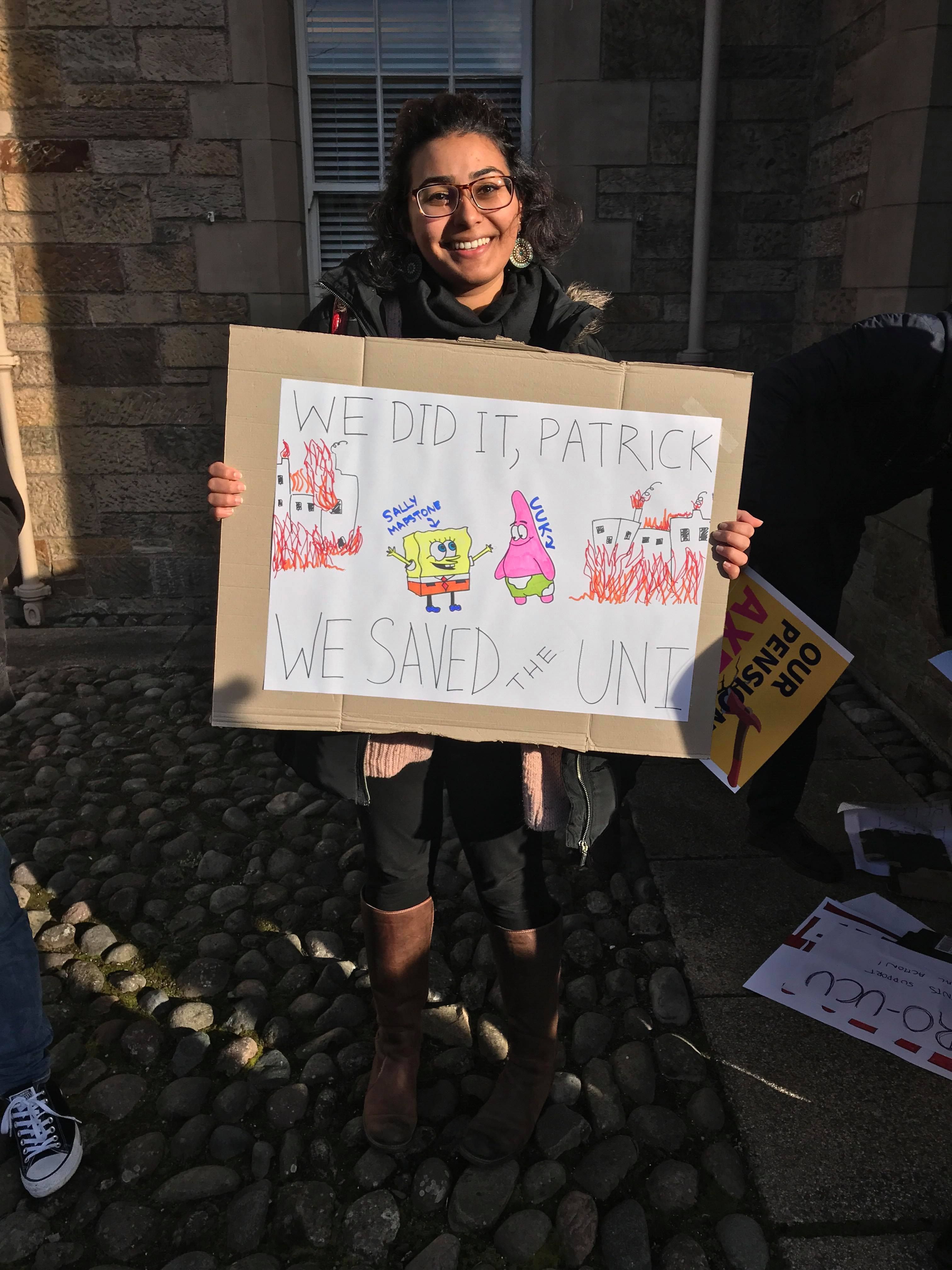 Image may contain: Dimples, Text, Banner, Smile, Portrait, Face, Hair, Black Hair, Crowd, Person, People, Human