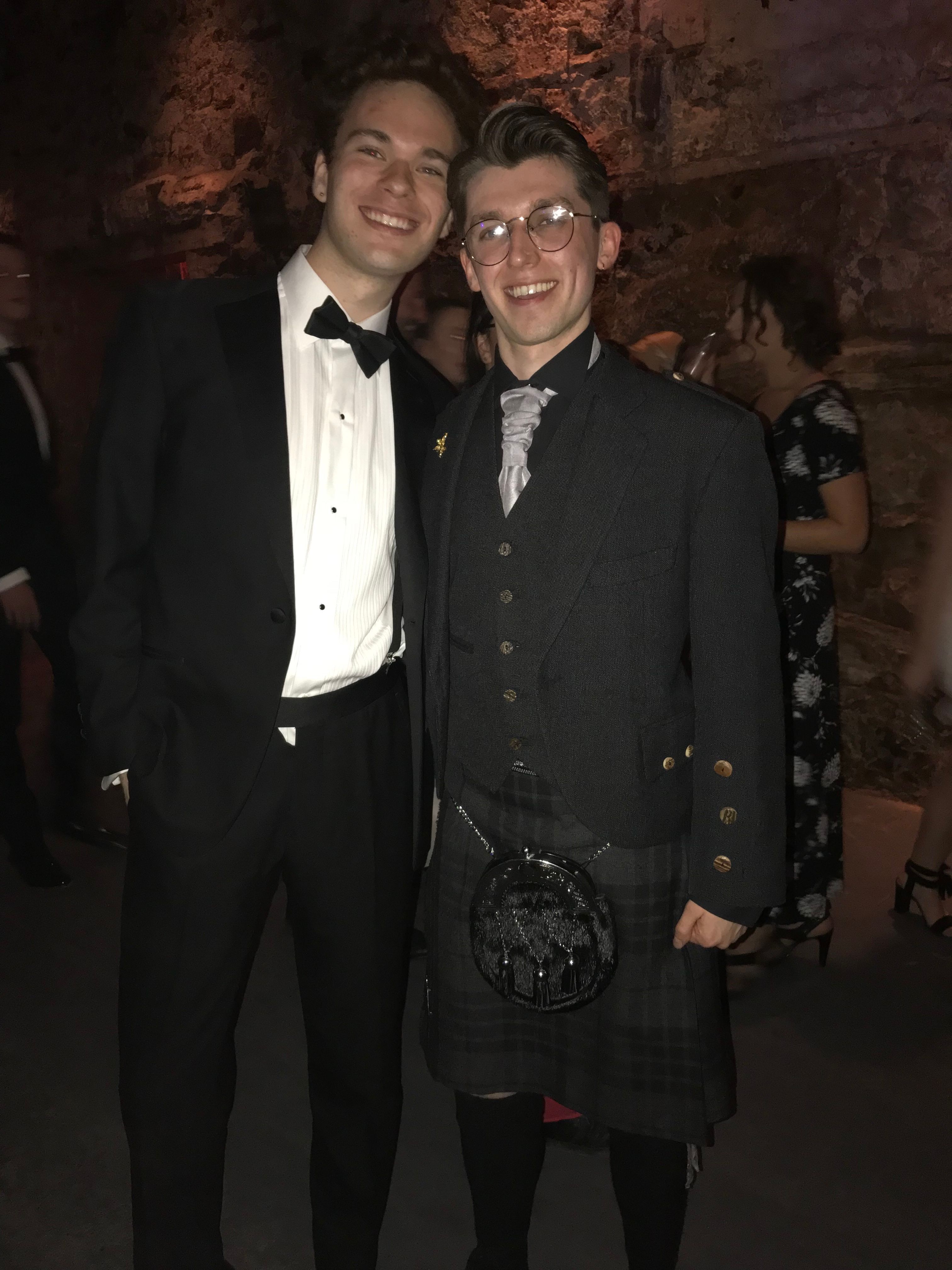 Image may contain: Tuxedo, Suit, Overcoat, Coat, Tartan, Skirt, Plaid, Kilt, Clothing, Person, People, Human