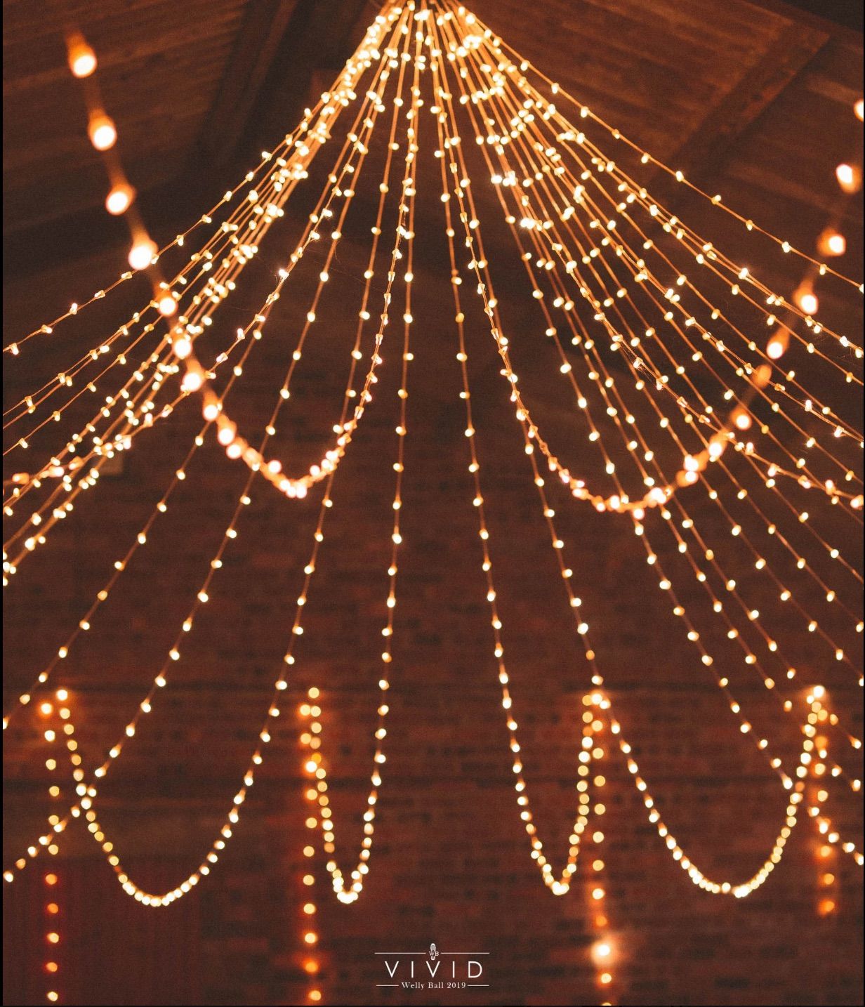 Image may contain: Crowd, Flare, Light, Lamp, Chandelier, Lighting