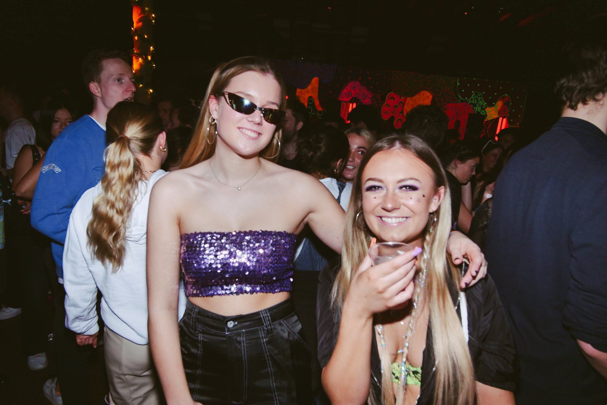 Image may contain: Night Club, Robe, Evening Dress, Fashion, Gown, Apparel, Clothing, Night Life, Club, Accessory, Sunglasses, Accessories, Person, Human