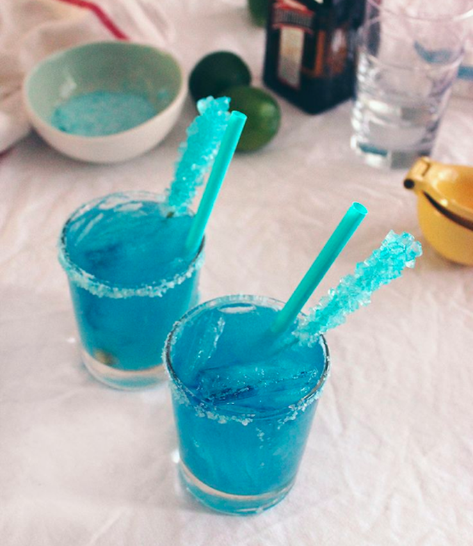 For something simple: Any cheap blue alcohol or add blue food colouring to any clear liquor. Line with blue sugar rim