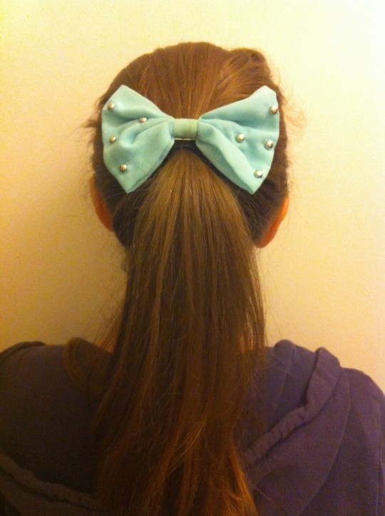 The bow offers a structured take on the scrunch, ensuring a more pulled-together look.