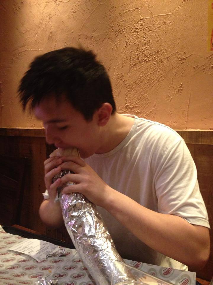 John going for his burrito with enthusiasm