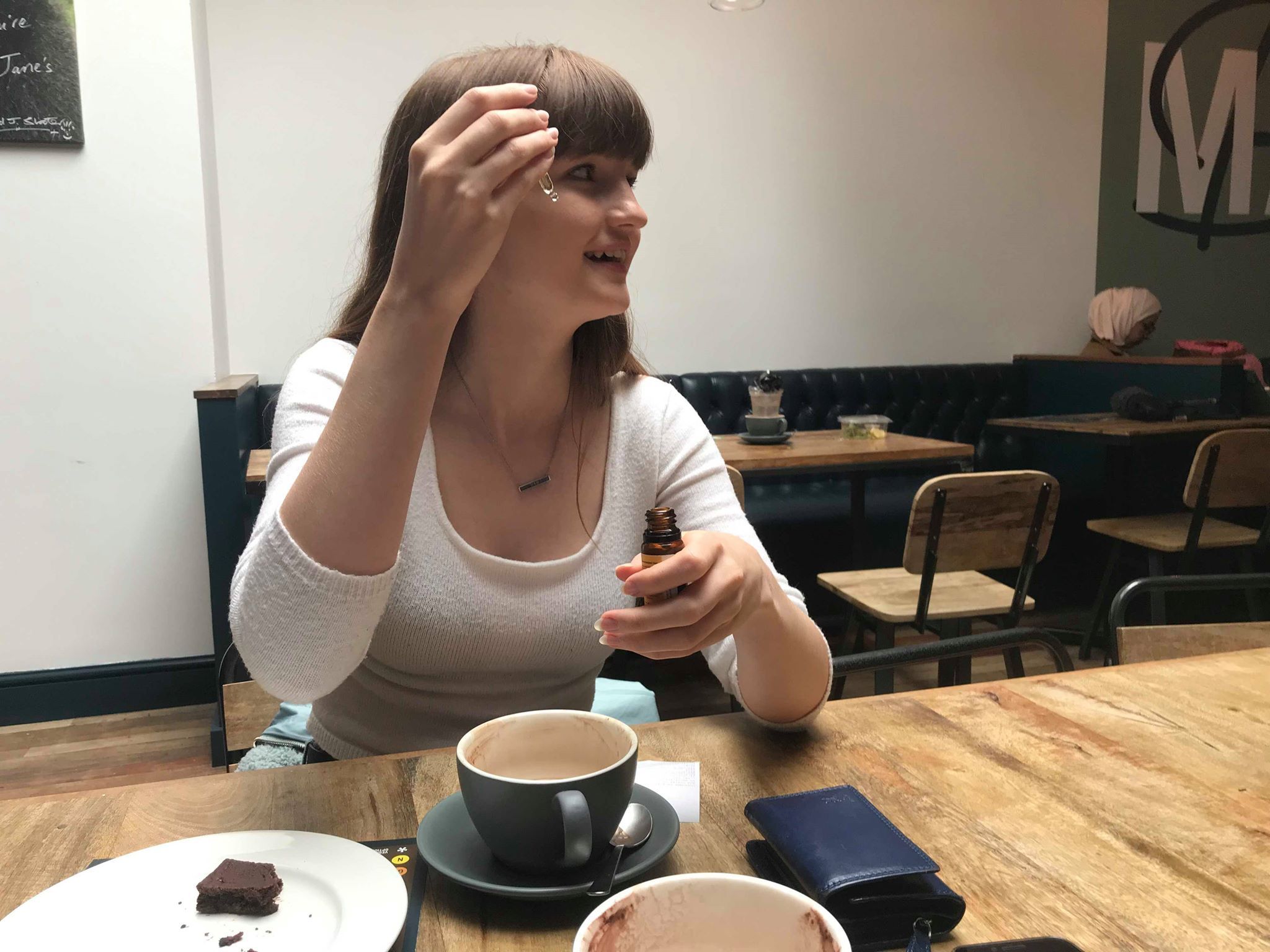 Image may contain: Wood, Cafe, Coffee Cup, Cup, Restaurant, Pottery, Saucer, Furniture, Chair, Person, Human