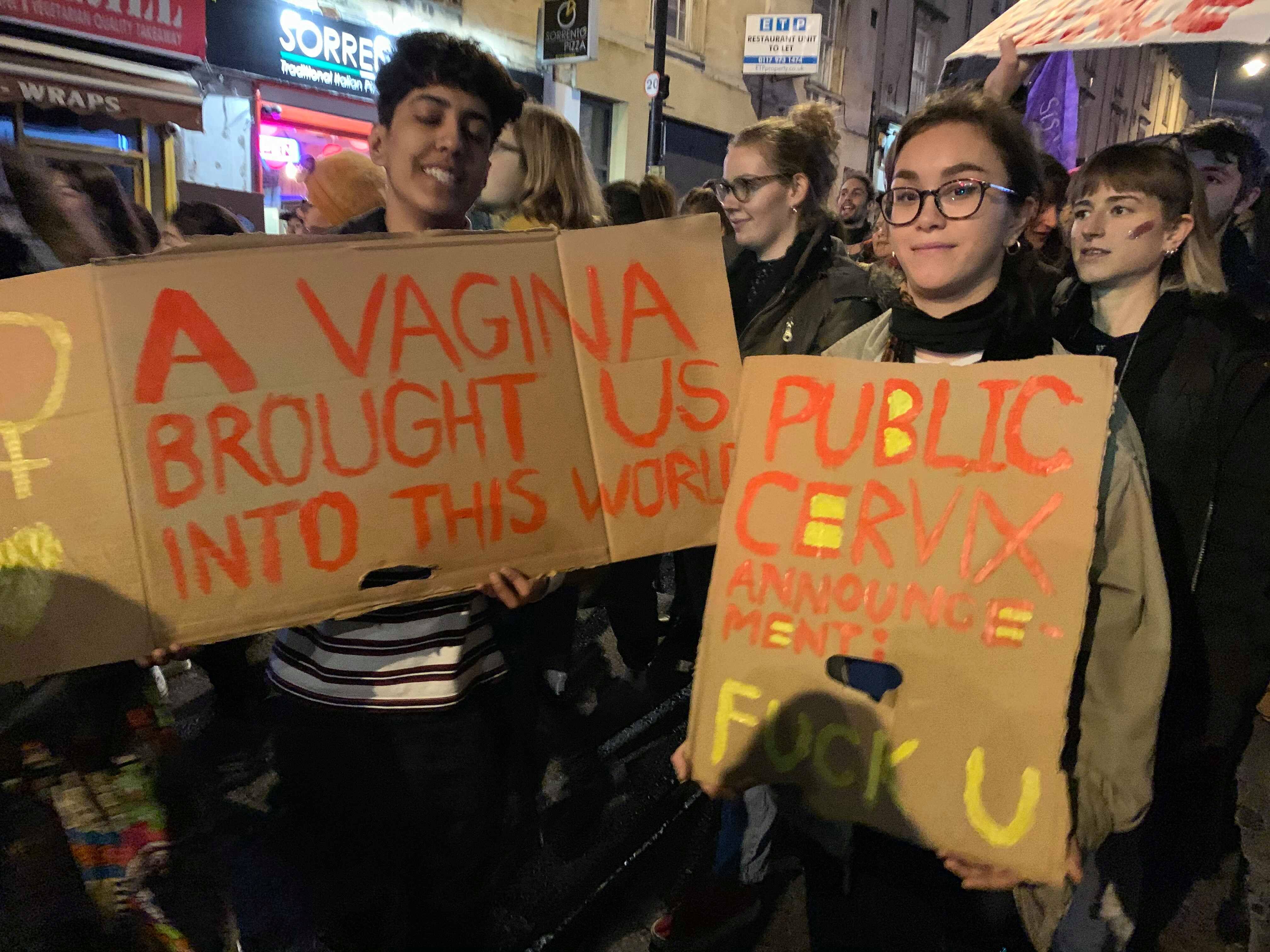 Image may contain: Parade, Crowd, Banner, Text, Person, Human