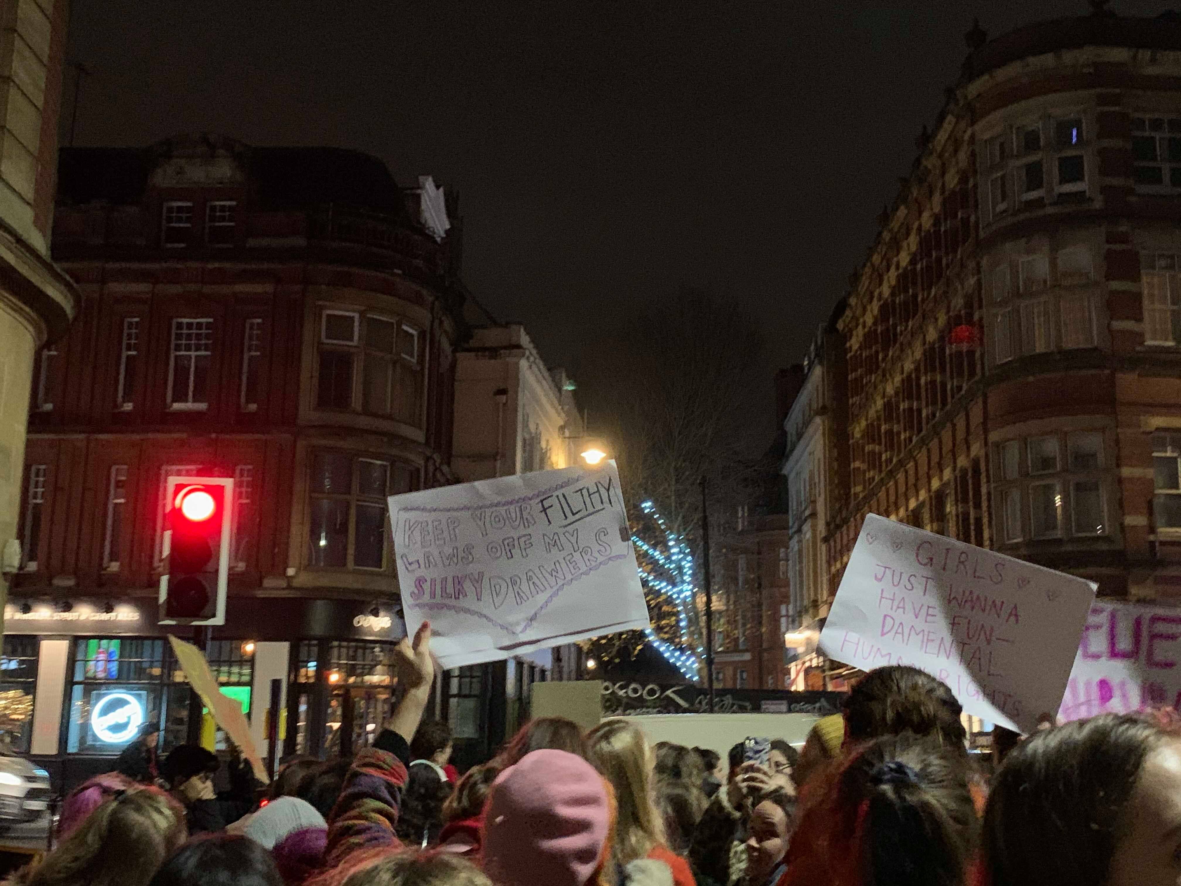 Image may contain: Pedestrian, Parade, Banner, Text, Crowd, Human, Person