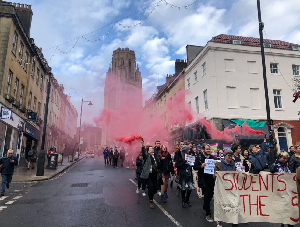 Image may contain: Smoke, Parade, Text, Pedestrian, Downtown, Festival, Car, Automobile, Vehicle, Transportation, Crowd, City, Town, Building, Street, Urban, Road, Human, Person
