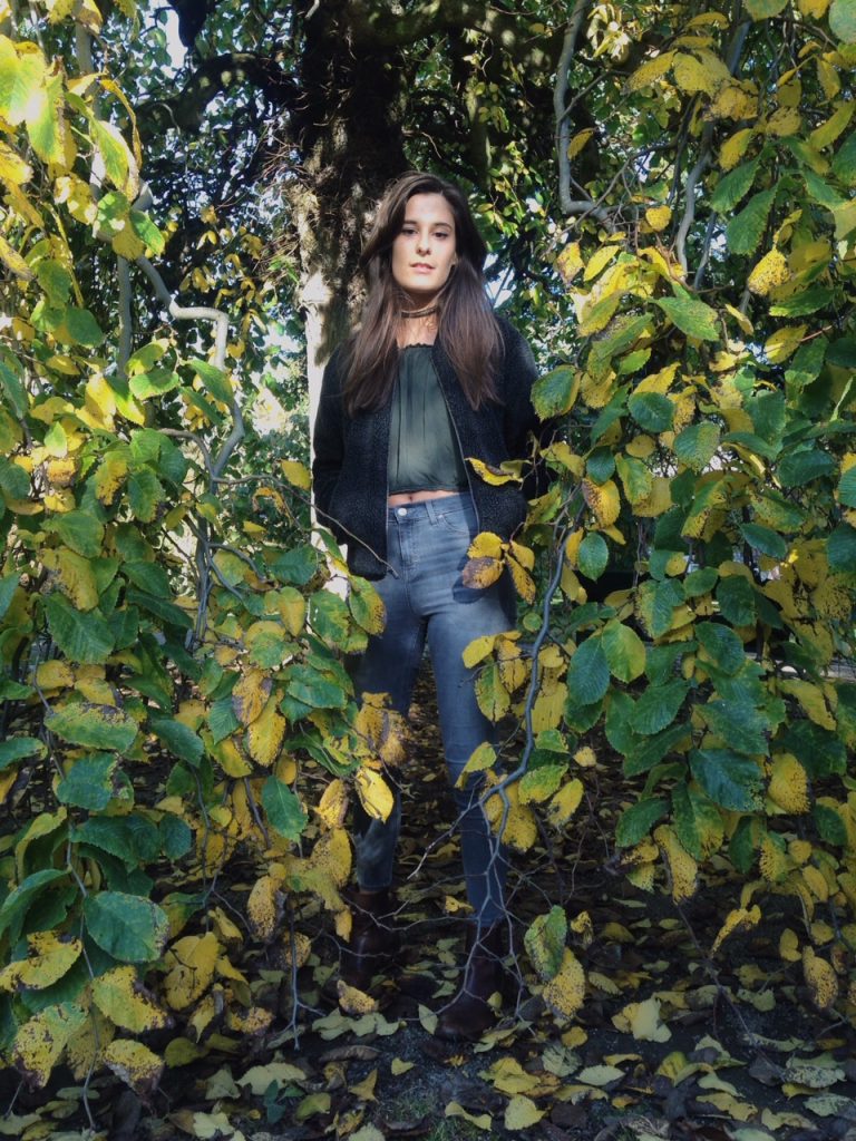 Fae wears Brandy Melville jacket and top, Topshop jeans, Urban Outfitters choker and boots.