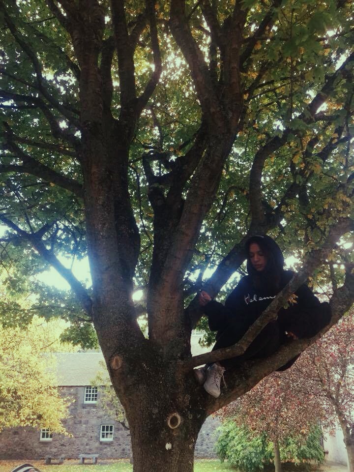 Raouiya wears Vetements hoodie, Topshop pants, and Converse trainers.