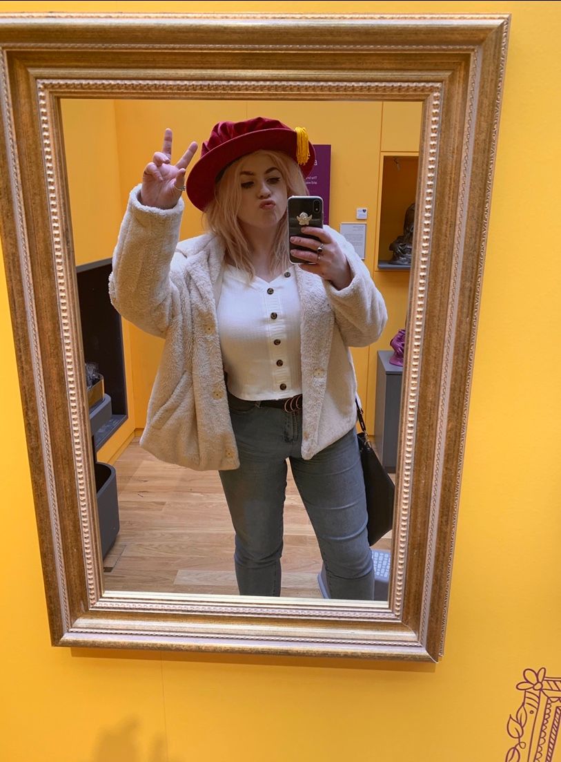 Image may contain: Hardwood, Wood, Long Sleeve, Electronics, Mobile Phone, Phone, Cell Phone, Home Decor, Sleeve, Person, Human, Hat, Apparel, Clothing