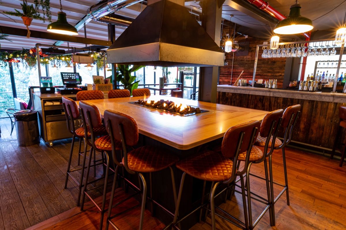 Image may contain: Alcohol, Drink, Beverage, Food Court, Food, Lighting, Bar Counter, Pub, Wood, Dining Table, Table, Dining Room, Restaurant, Room, Interior Design, Indoors, Chair, Furniture