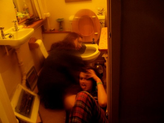 A much too common scene for students; one vomits, the other sees a sexy photo opportunity