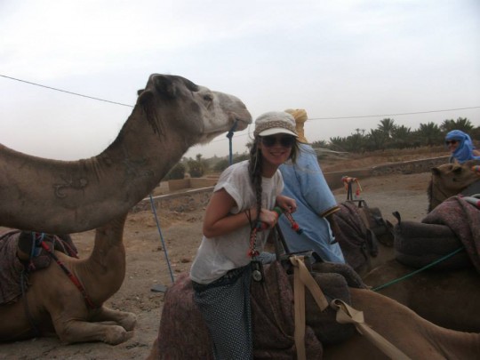 Sinead Kelly attempting to dodge a camel.