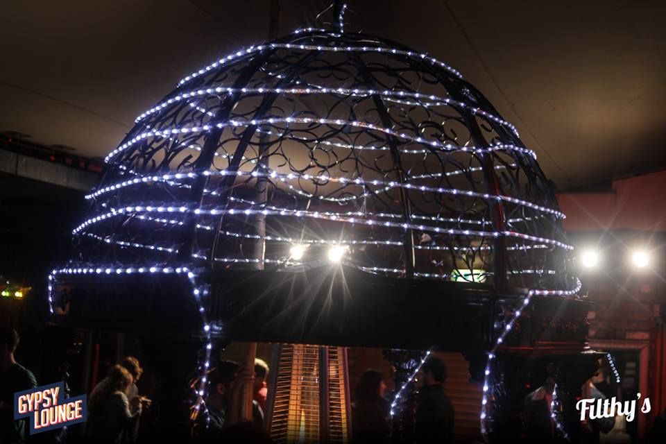 Image may contain: Face, Chandelier, Lamp, Lighting, Human, Person, Building, Architecture, Dome