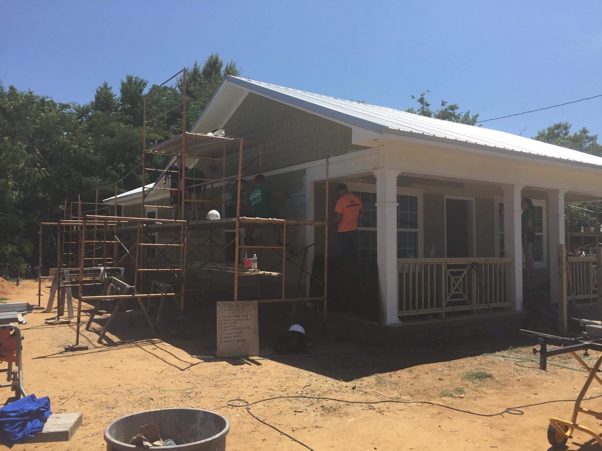Image may contain: House, Patio, Plywood, Construction, Person, Human, Housing, Building, Porch, Wood