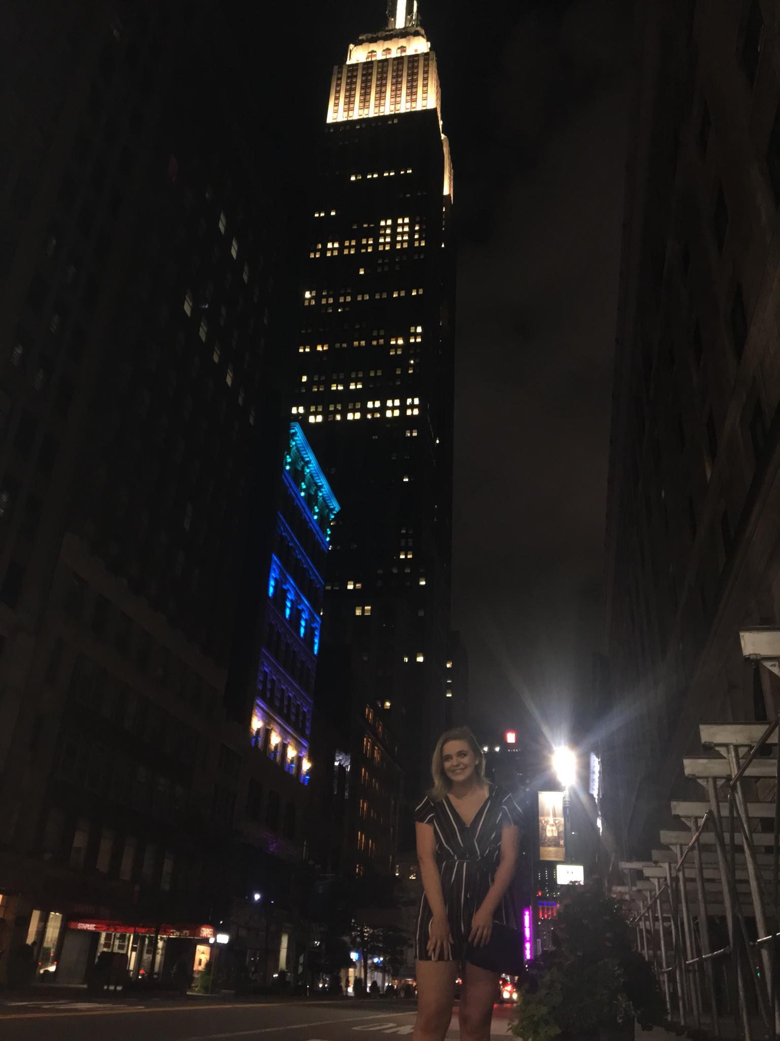 Image may contain: Street, Pedestrian, High Rise, Office Building, Architecture, Tarmac, Asphalt, Road, Downtown, Night Life, Human, Person, City, Urban, Metropolis, Building, Town
