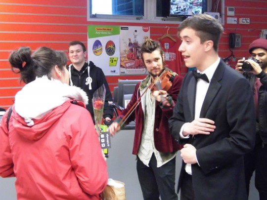 James sings in the student shop before being kicked out by the employee in the background