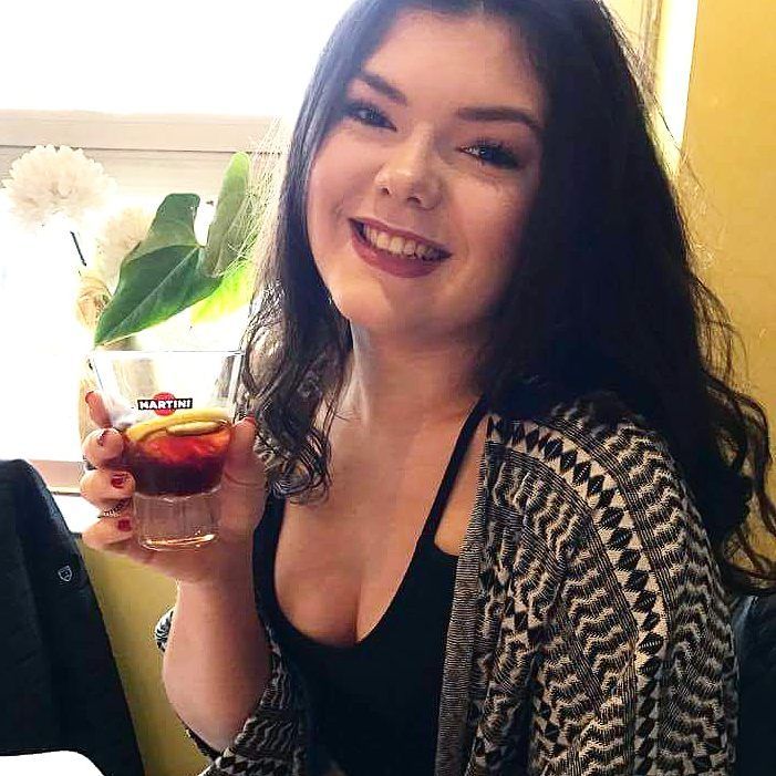 Image may contain: Glass, Smile, Portrait, Face, Drink, Beverage, Vase, Pottery, Potted Plant, Plant, Jar, Flora, Person, People, Human