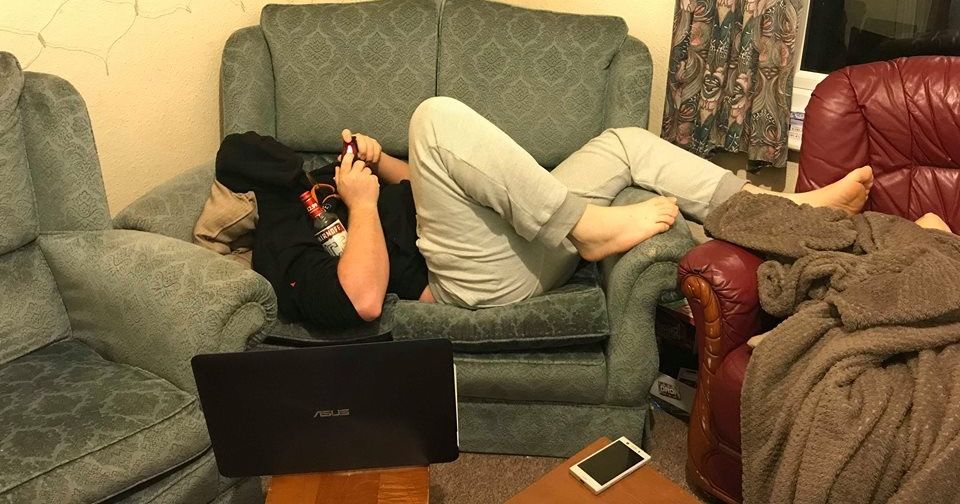 Image may contain: Armchair, Cushion, Person, Human, Laptop, Electronics, Computer, Pc, Chair, Furniture, Couch