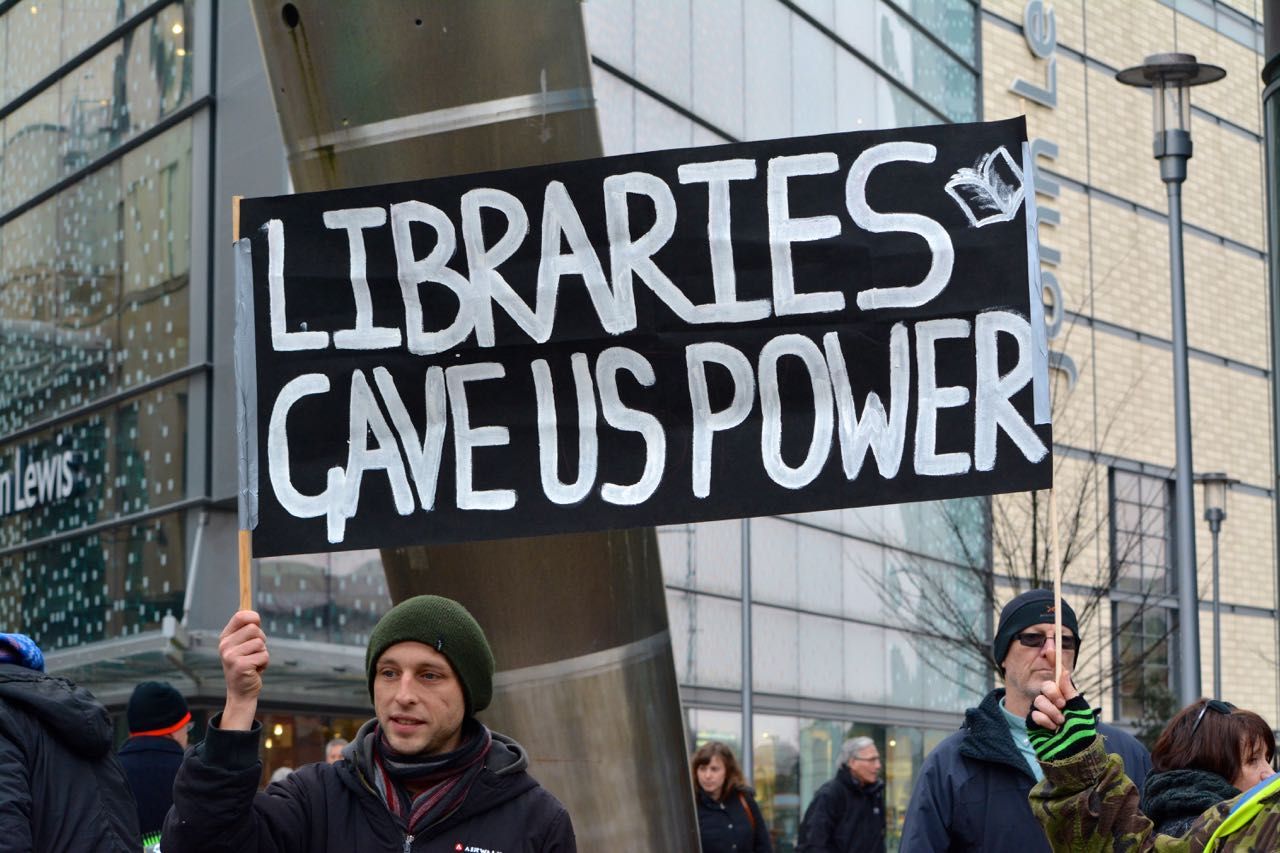 Image may contain: Crowd, Text, Banner, Hat, Clothing, Cap, Beanie, Person, People, Human