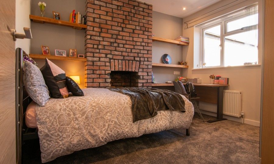 Image may contain: Living Room, Building, Housing, Home Decor, Interior Design, Hearth, Room, Bedroom, Pillow, Cushion, Fireplace, Indoors, Bed, Furniture