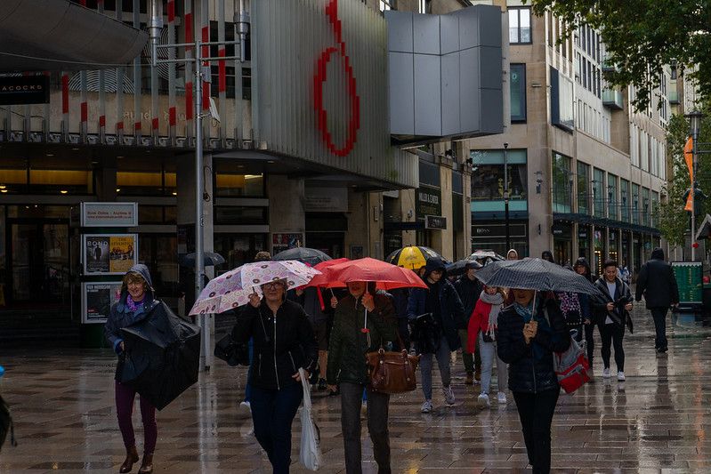 Image may contain: Apparel, Clothing, Pedestrian, Umbrella, Canopy, Person, Human