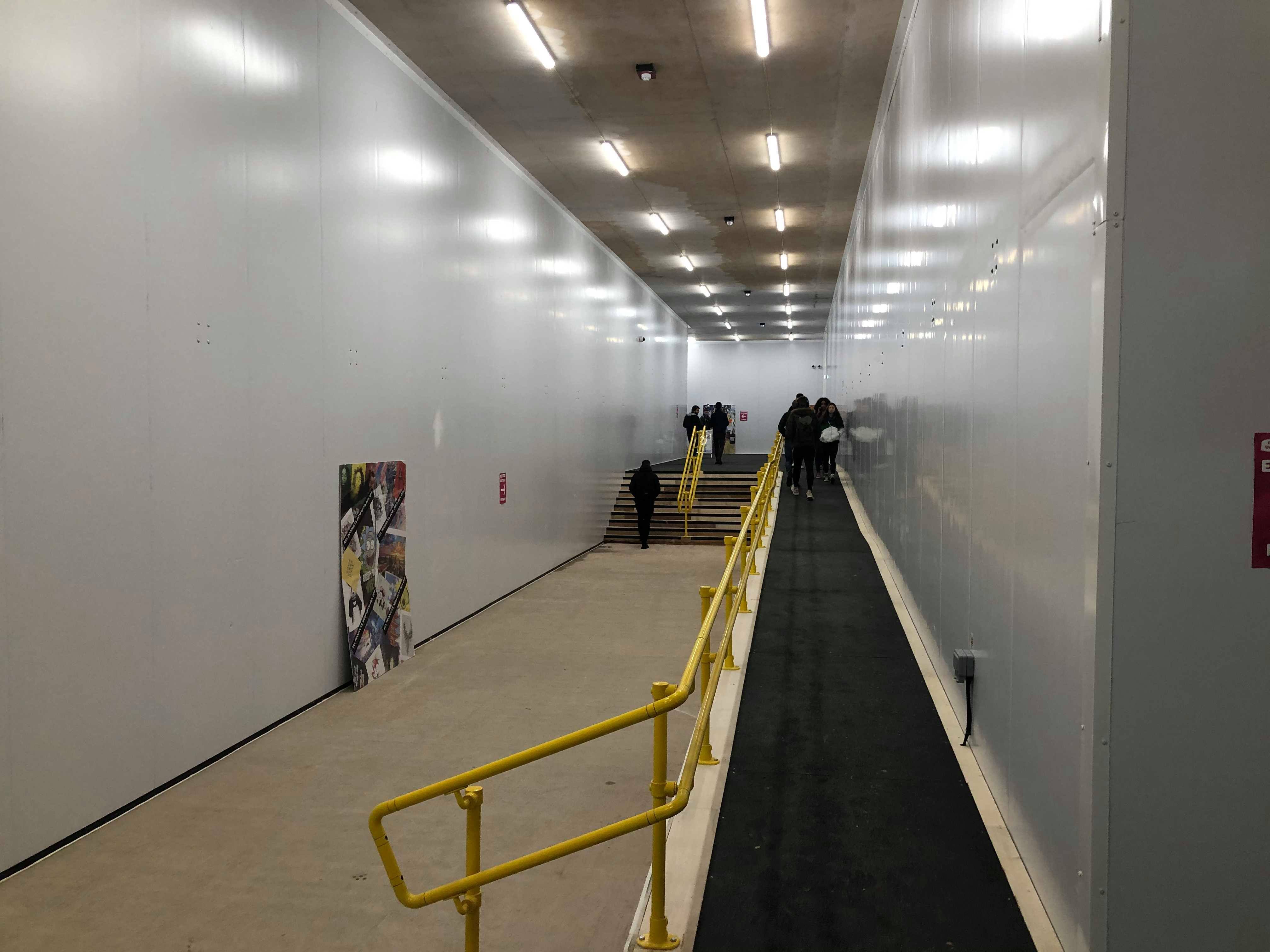 Image may contain: Corridor, Person, Human, Banister, Handrail