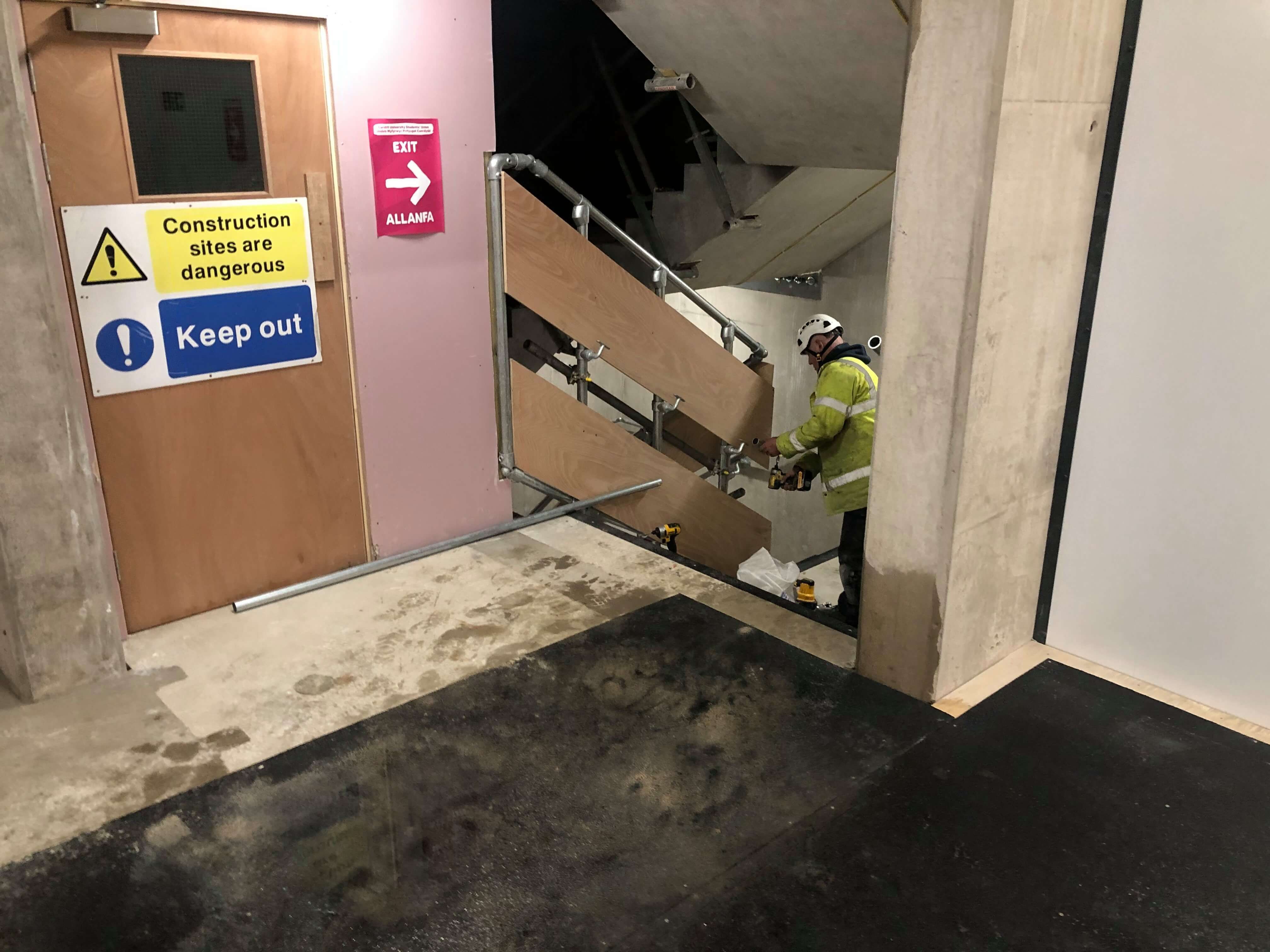 Image may contain: Helmet, Clothing, Apparel, Plywood, Floor, Machine, Wood, Handrail, Banister, Flooring, Person, Human