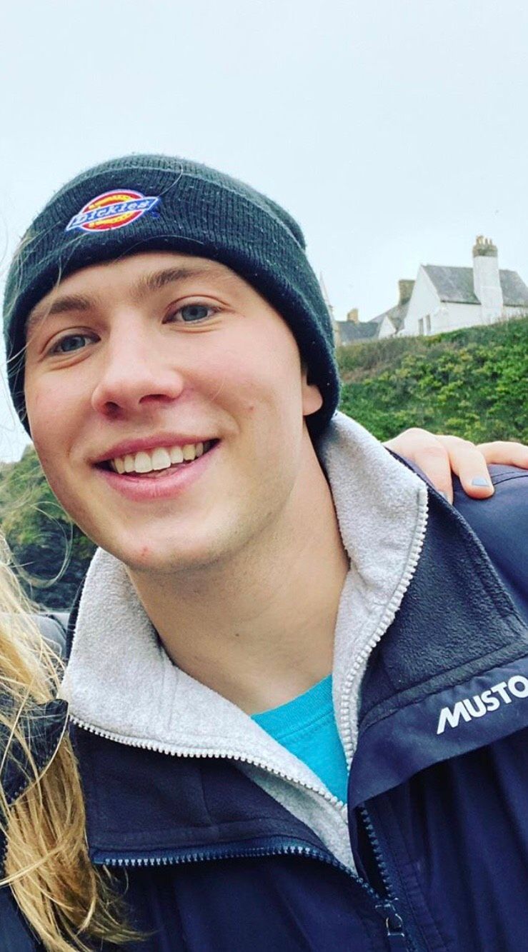 Image may contain: Man, Beanie, Cap, Hat, Smile, Dimples, Clothing, Apparel, Human, Face, Person