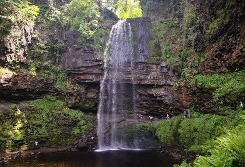 Image may contain: Rock, Forest, Woodland, Jungle, Person, Human, Waterfall, River, Water, Tree, Land, Rainforest, Outdoors, Nature, Vegetation, Plant