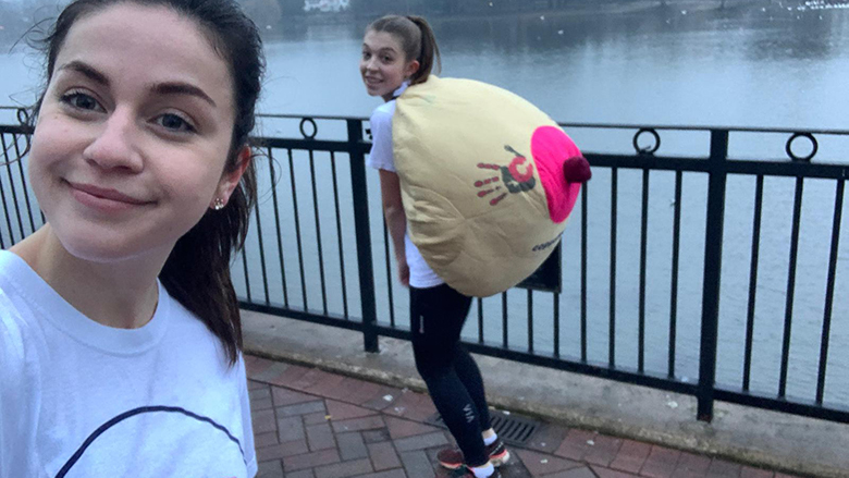 two girls with an inflatable boob